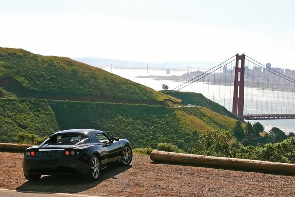 Sports car on the background of a metal bridge