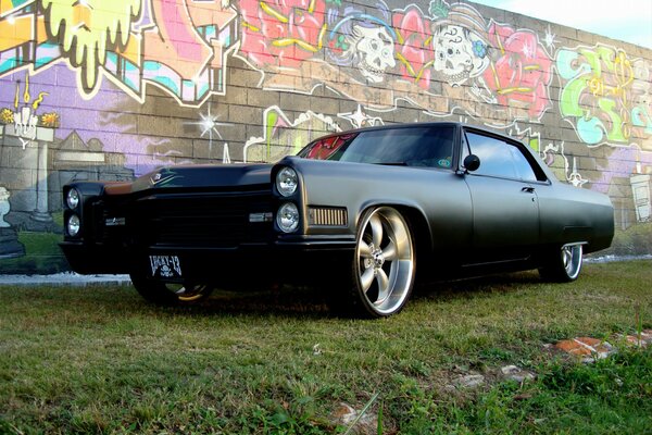 Black matte car on graffiti background