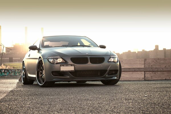 Matte BMW on the background of sunset in an industrial area