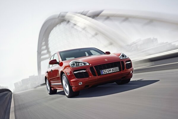 Red Porsche on the background of a modern urban structure