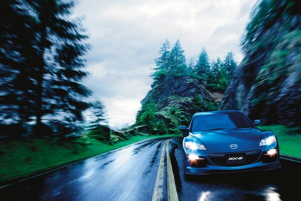 Mazda rx 8 drives at speed on the road