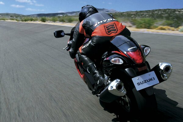 Rear view of a Suzuki sport bike at speed on the highway