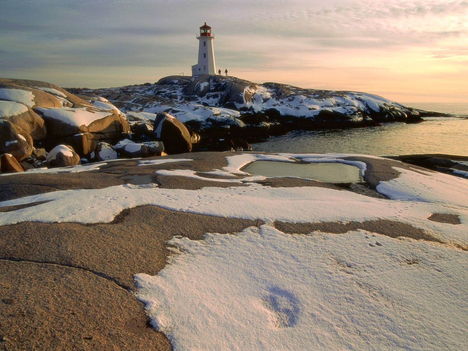 lighthouse snow stones people