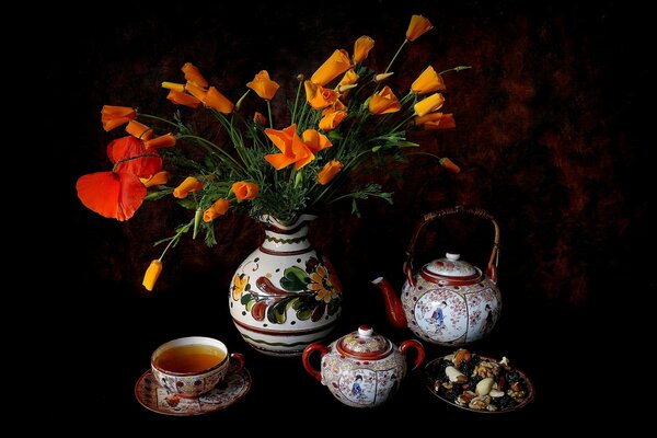 Still life with tea, sweets and flowers