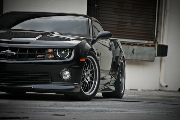 Black chevrolet on the background of the building