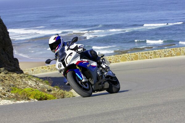 A biker s journey along a mountain road by the sea