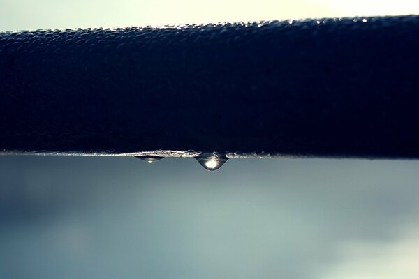 Reflection of light in a drop of water on the pier