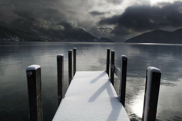 Winter lake with a pier inspired sadness