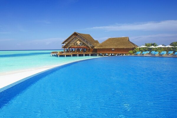 Swimming pool near the sea in sunny weather