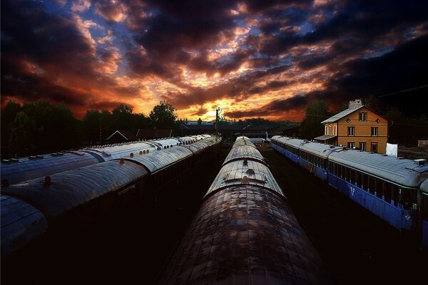 At sunset, the trains arrive at the depot