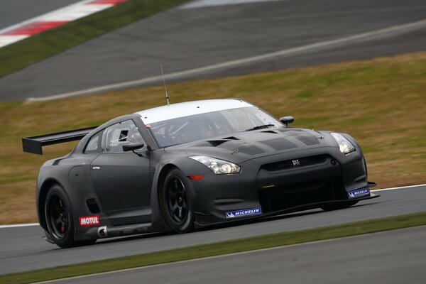 Black racing car on a high-speed track