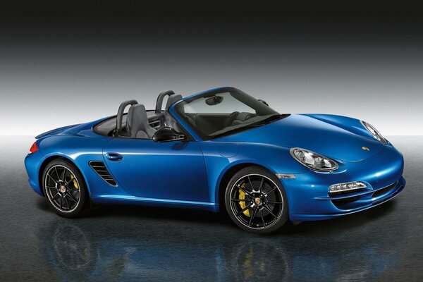 Blue Porsche Boxster on a grey background