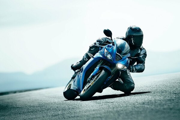 Blue sport bike driver in helmet