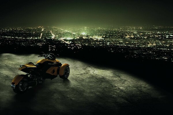 A sports motorcycle looks at the lights of a distant night city