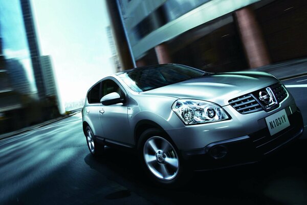 Brutal photo of a nissan dualis car among city buildings