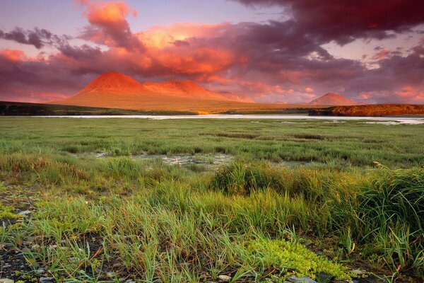 Landscape of mountains, clouds and grass