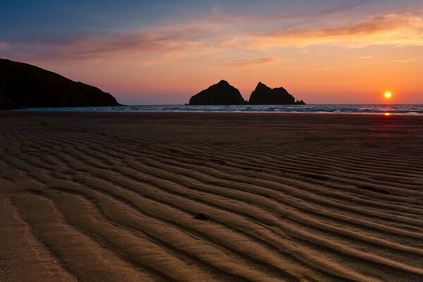 Silhouettes of rocks in the rays of the setting sun