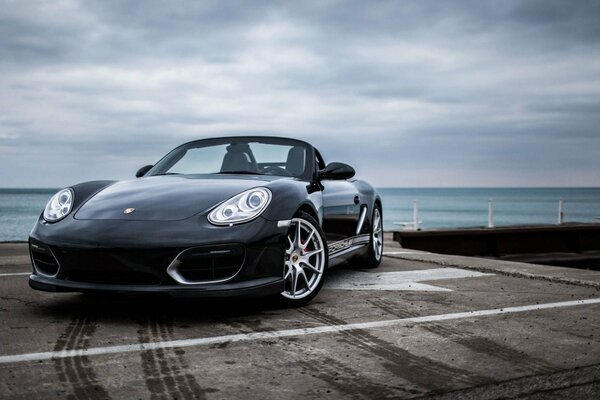 Black Porsche on a beautiful sea background