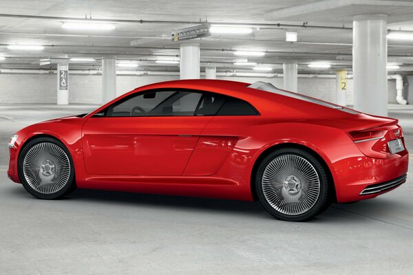 There is a beautiful, red car in the parking lot