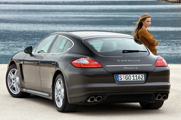 Ragazza con Porsche sullo sfondo dell acqua