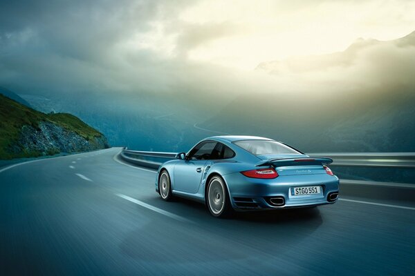 Porsche rushes down the road rear view