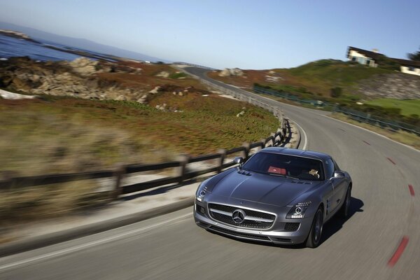 Mercedes Benz drives at speed on the road