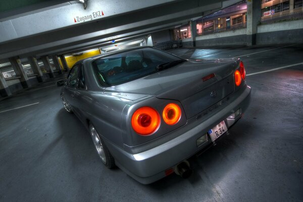 Dark Nissan in a multi-level parking lot