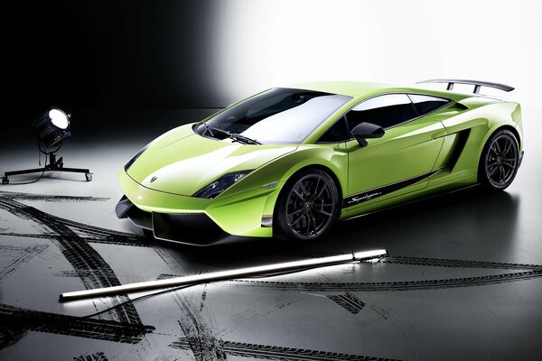 A green Lamborghini car in the spotlight