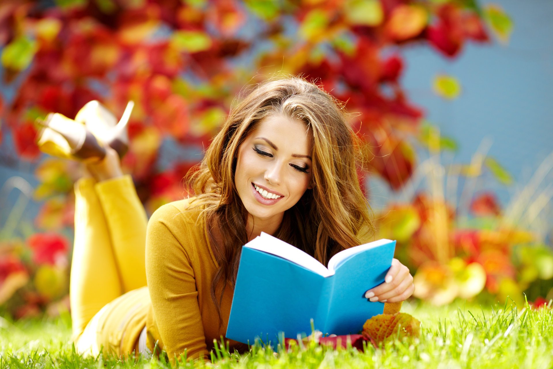 girl smile brown hair book grass reads autumn