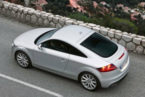 White Audi TT rides on the road