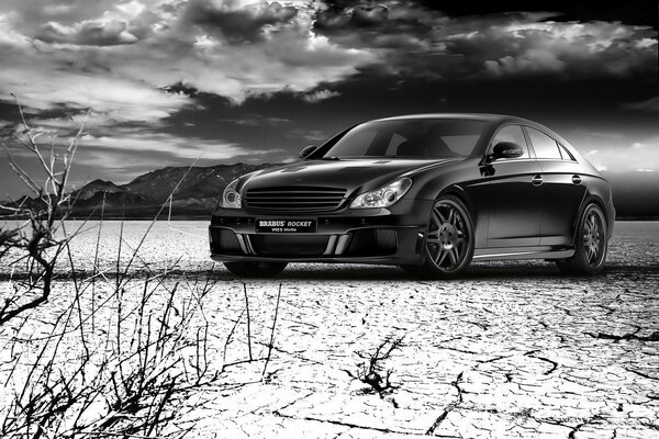 Black and white photo of a Mercedes on the sand