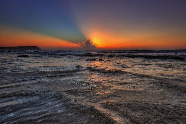 A bright sunset from the clouds to the sea