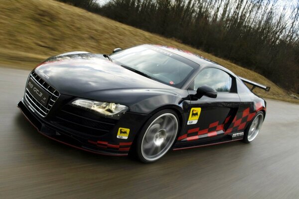 A black Audi rushes along the highway