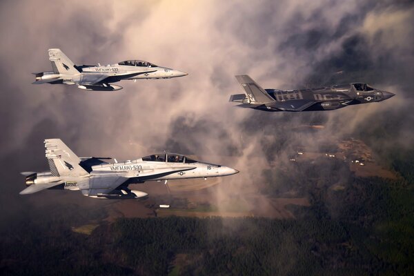 F-35 fighters in flight in the clouds