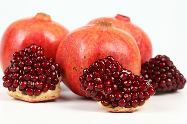 Ripe sweet pomegranate on a white background