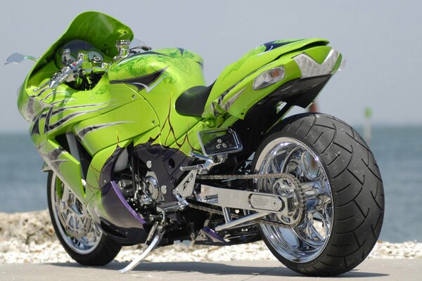 Green sports bike by the water