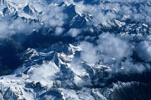 Snow-capped mountains with white clouds