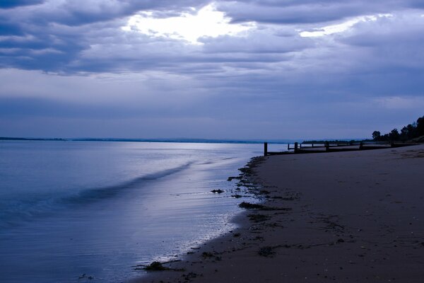 Beach on the sea against the background of twilight