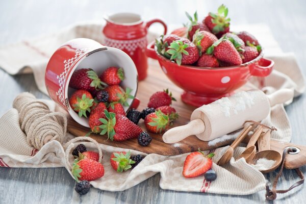 Strawberries and a wooden rolling pin