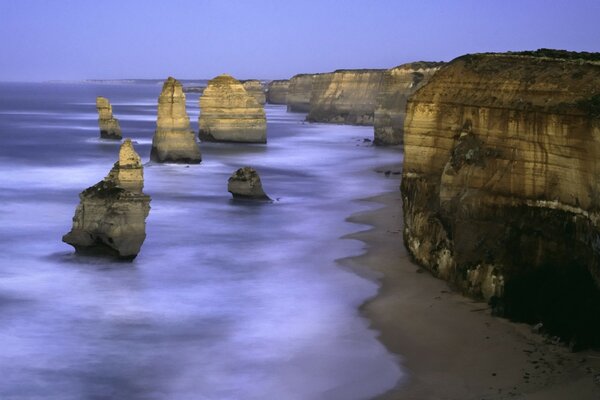 A wave washes the rocky shore