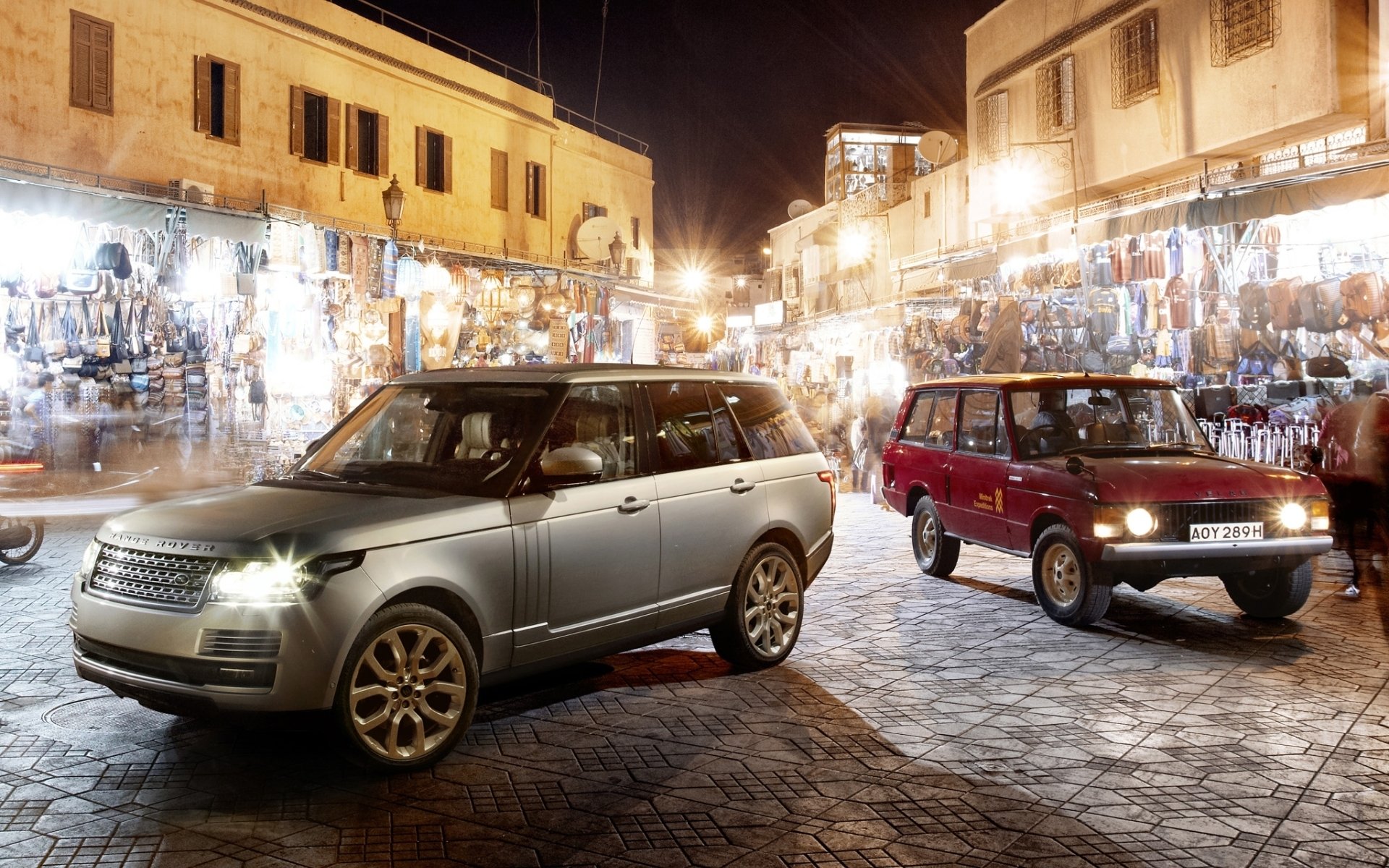 land rover range rover land rover range rover old and new front market night background