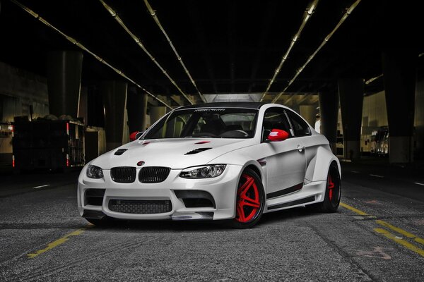 White BMW with red wheels