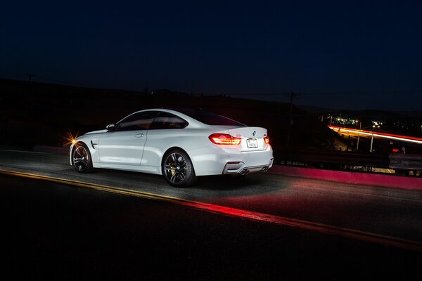 Bianco BMW Coupé f82 sulla strada di notte