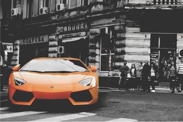 Coche de color de pie en la calle de la ciudad en blanco y negro