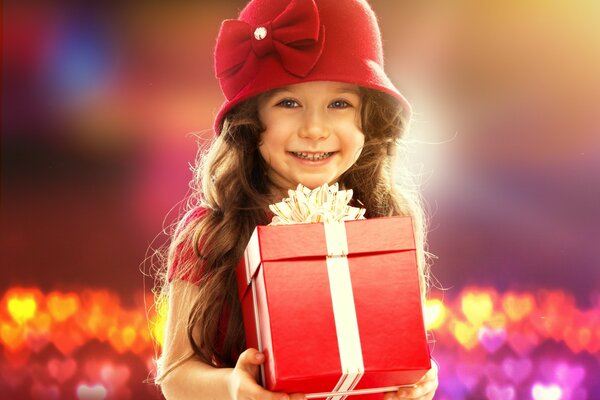 A girl in a red hat with a gift