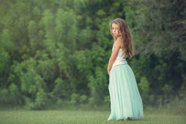 A girl with long hair on a forest background