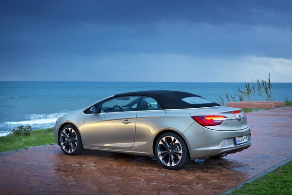 Gray Opel standing by the seashore