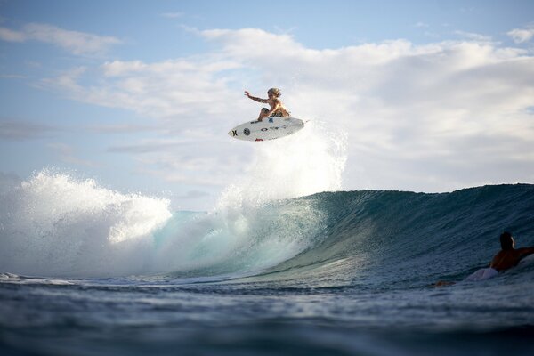 A girl on a surfboard conquers the waves