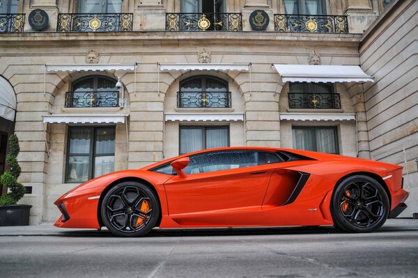 Orange Lamborghini Aventador on the background of the building