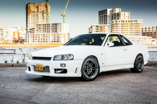 Snow-white nissan on the background of the urban landscape